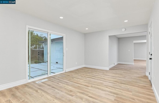 unfurnished room with light hardwood / wood-style floors