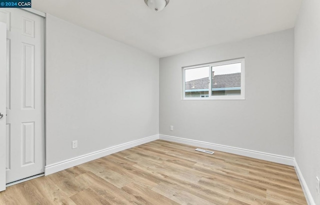 spare room featuring light wood-type flooring