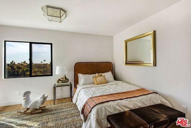 bedroom with hardwood / wood-style floors