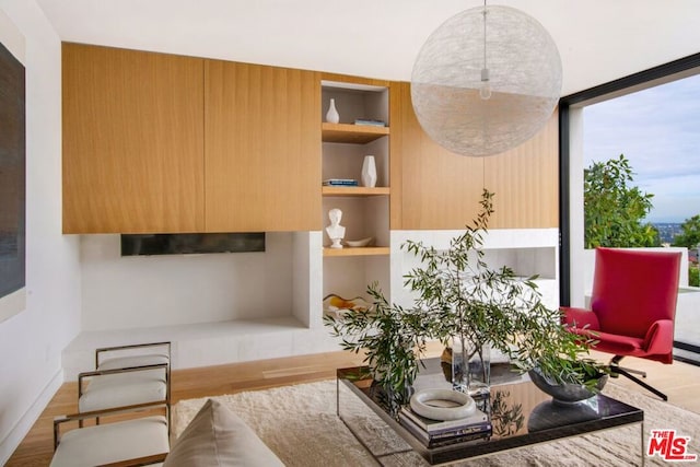 sitting room with floor to ceiling windows and hardwood / wood-style flooring