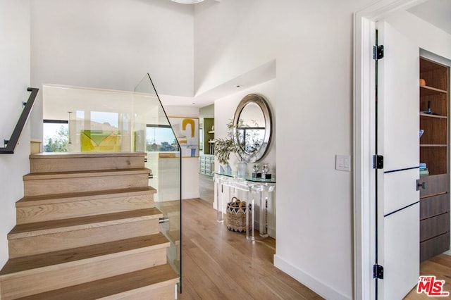 staircase with hardwood / wood-style flooring