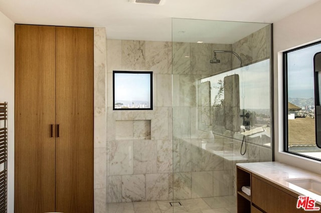 bathroom featuring vanity and a tile shower