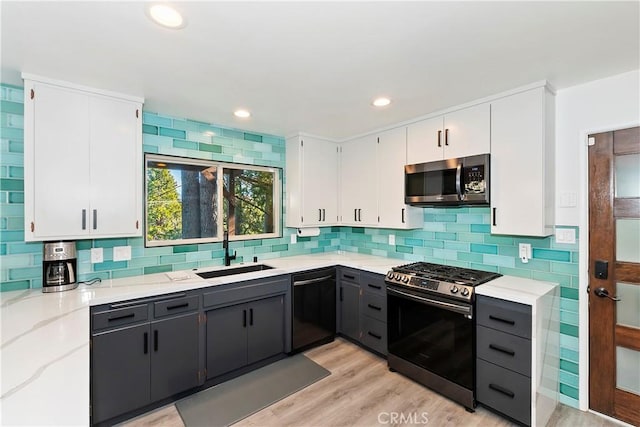 kitchen featuring white cabinets, appliances with stainless steel finishes, and sink