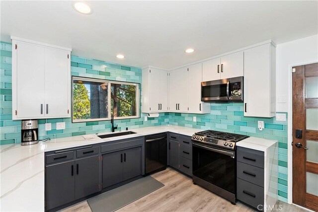 762 Zurich Dr, Lake Arrowhead, CA 92352 - kitchen with appliances with stainless steel finishes, a sink, light stone countertops, white cabinets, and backsplash