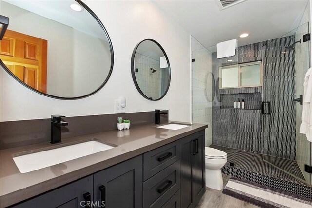 762 Zurich Dr, Lake Arrowhead, CA 92352 - bathroom featuring a stall shower, toilet, double vanity, and recessed lighting