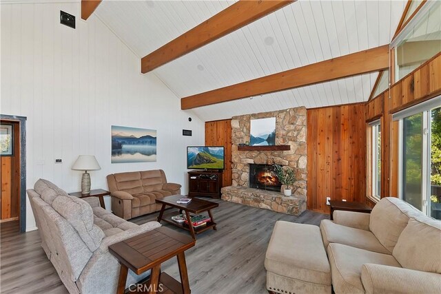 762 Zurich Dr, Lake Arrowhead, CA 92352 - living room with wood finished floors, beamed ceiling, a stone fireplace, high vaulted ceiling, and wood walls