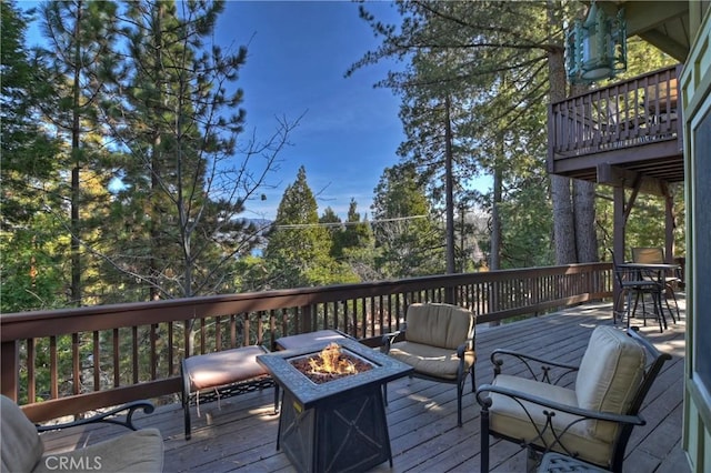wooden deck featuring a fire pit