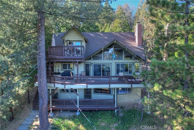 back of property with a wooden deck