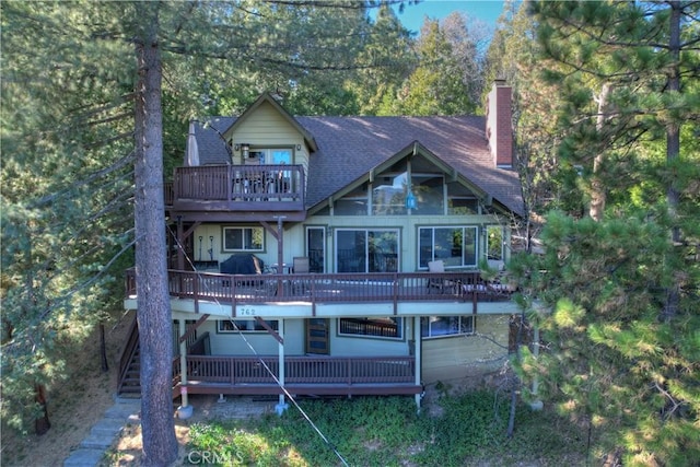762 Zurich Dr, Lake Arrowhead, CA 92352 - rear view of house featuring a chimney, a balcony, stairs, roof with shingles, and a deck
