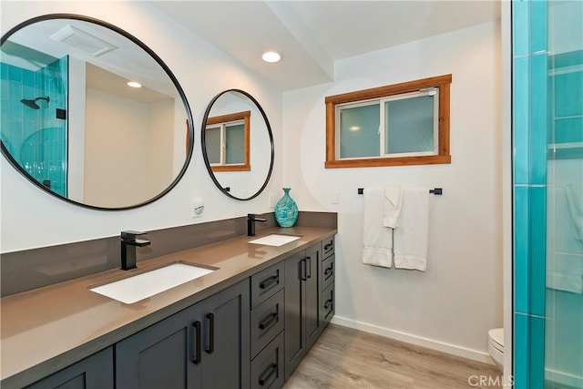 762 Zurich Dr, Lake Arrowhead, CA 92352 - full bathroom featuring wood finished floors, toilet, baseboards, an enclosed shower, and double vanity