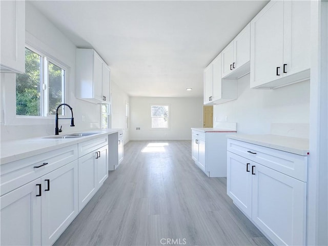 kitchen featuring sink and white cabinetry