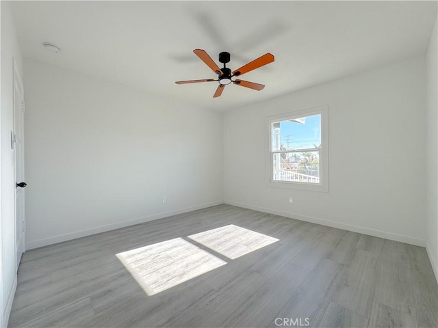 unfurnished room with ceiling fan and light hardwood / wood-style floors