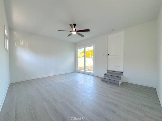 unfurnished living room featuring ceiling fan and light hardwood / wood-style floors