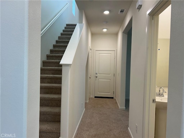 corridor with light colored carpet