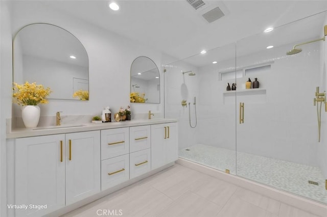 bathroom featuring vanity, tile patterned flooring, and walk in shower