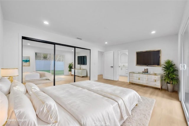 bedroom featuring access to exterior and light hardwood / wood-style flooring