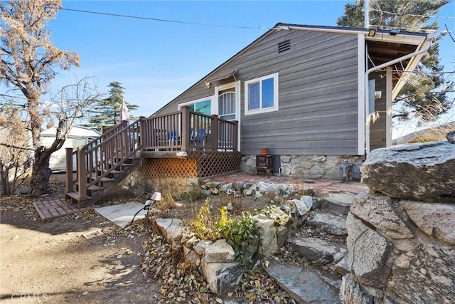 back of property featuring a wooden deck