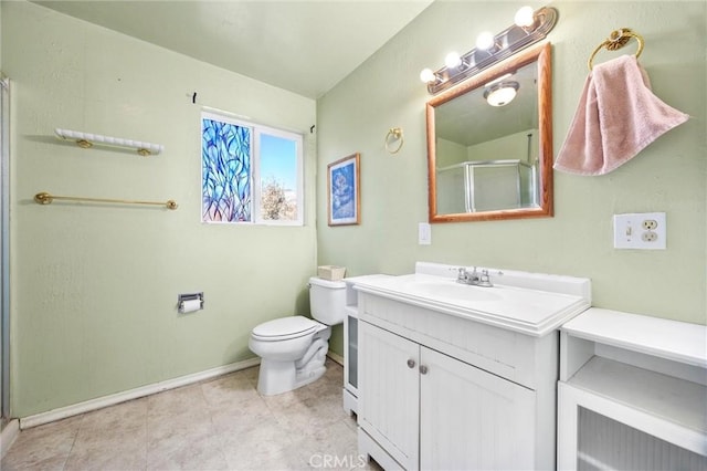 full bathroom featuring toilet, a shower stall, vanity, and baseboards