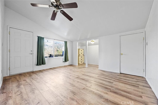 unfurnished bedroom with a ceiling fan, vaulted ceiling, and light wood finished floors