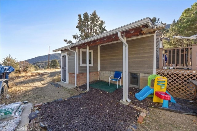 exterior space featuring a playground and a mountain view