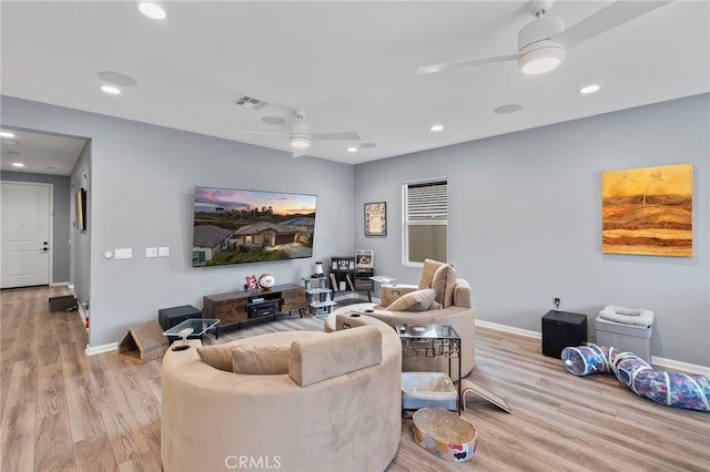 living room with ceiling fan and light hardwood / wood-style floors