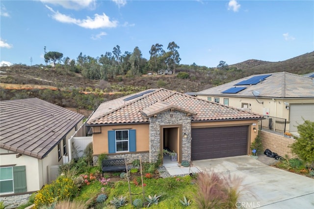 mediterranean / spanish-style home featuring a garage and a mountain view