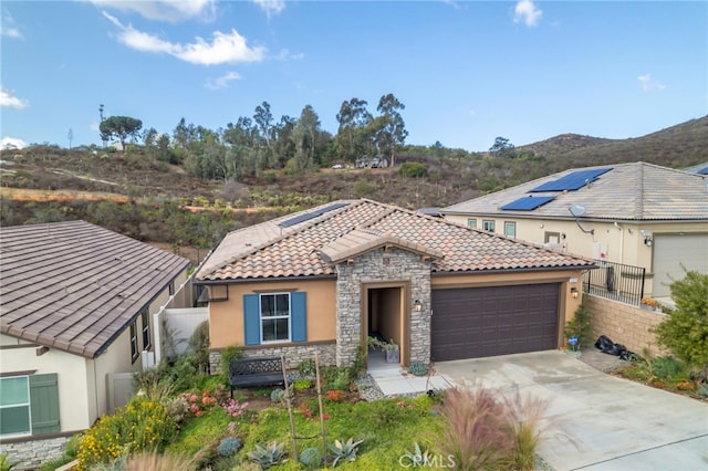 view of front of property featuring a garage and a mountain view