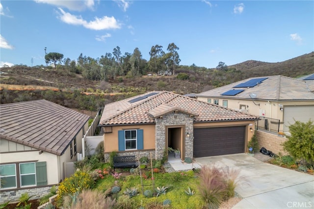 view of front of property featuring a garage and a mountain view