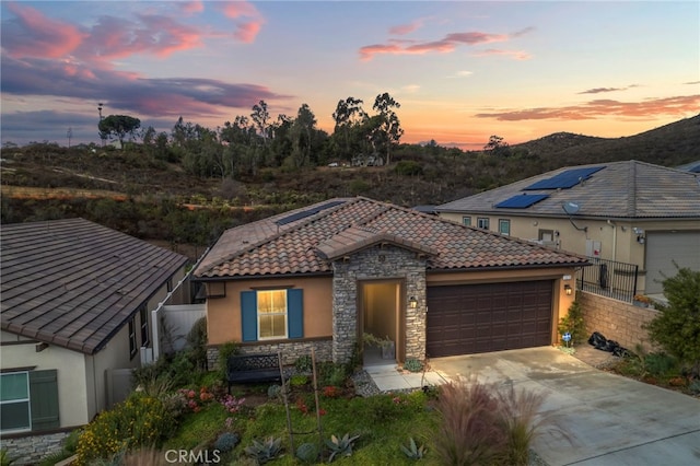 view of front of property with a garage and a mountain view