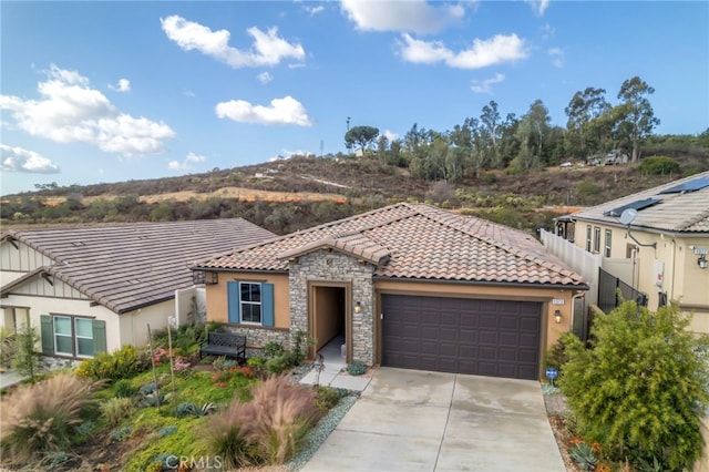 mediterranean / spanish-style house with a garage