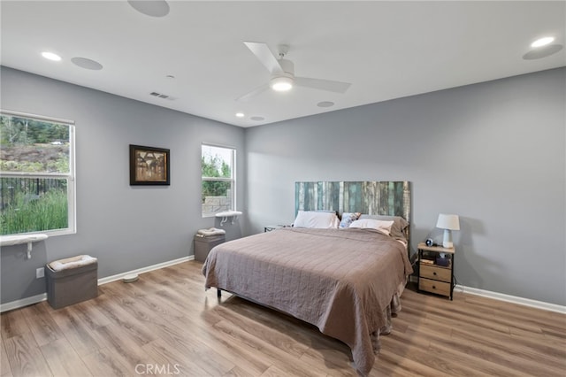 bedroom with ceiling fan and light wood-type flooring