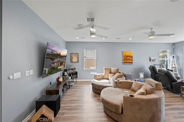 living room with ceiling fan and light hardwood / wood-style floors