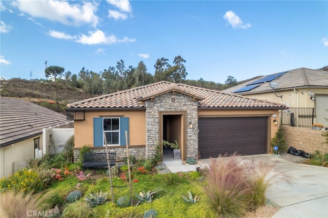 mediterranean / spanish home featuring a garage