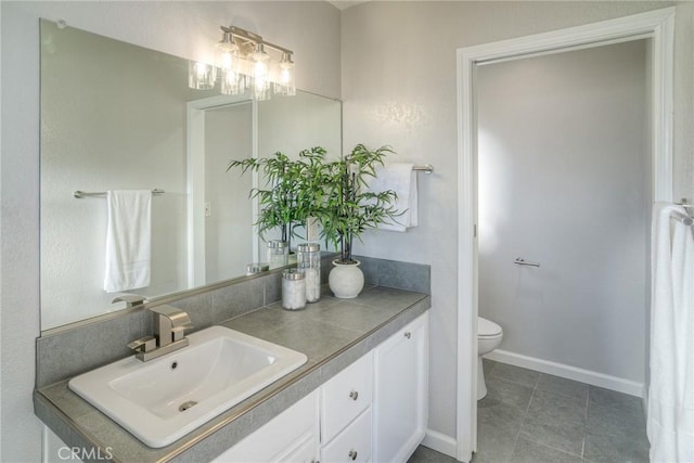 bathroom featuring vanity, tile patterned floors, and toilet