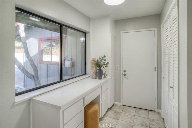 foyer entrance with a wealth of natural light and light tile patterned floors