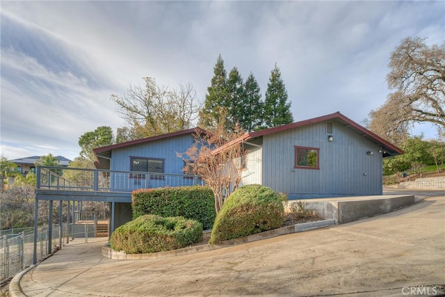 view of side of home featuring a wooden deck