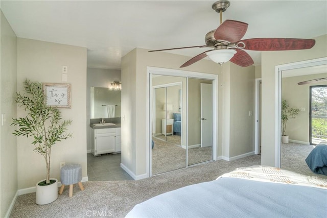 bedroom featuring connected bathroom, sink, ceiling fan, light carpet, and french doors