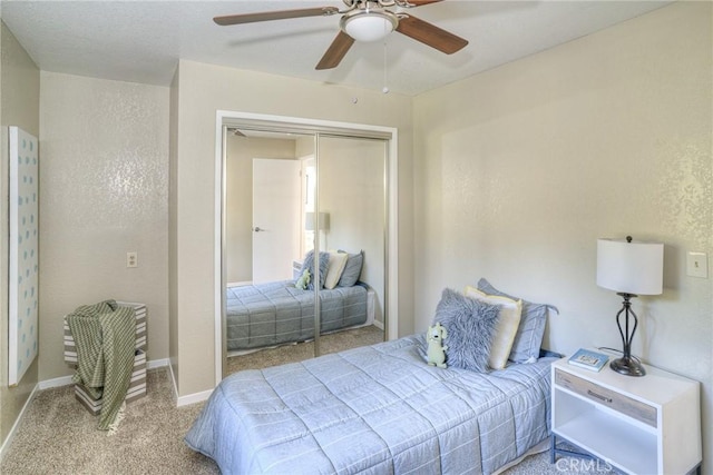 carpeted bedroom featuring a closet and ceiling fan