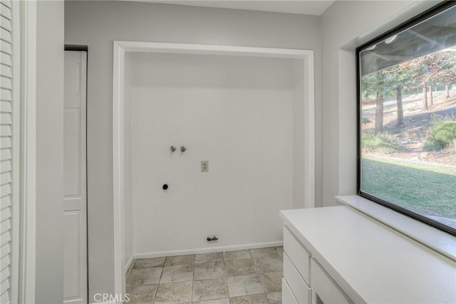 clothes washing area featuring cabinets, washer hookup, and hookup for an electric dryer