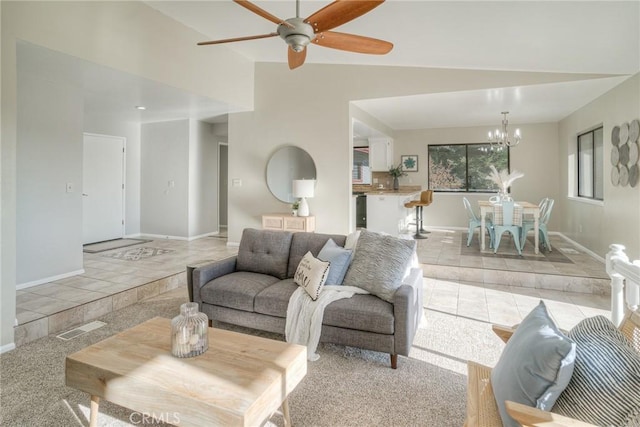 living room with light carpet, ceiling fan with notable chandelier, and vaulted ceiling