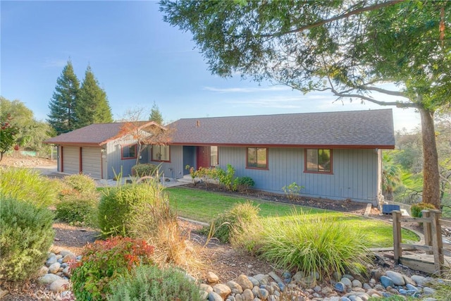 ranch-style house featuring a garage and a front yard