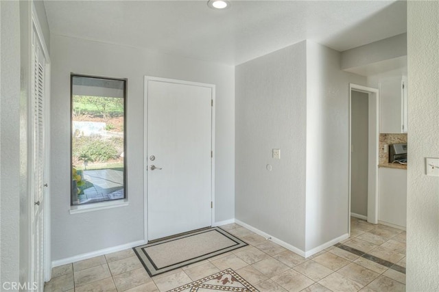 entrance foyer with light tile patterned flooring