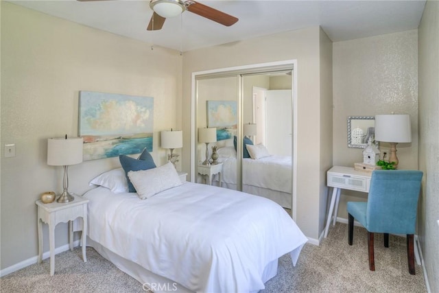 bedroom featuring ceiling fan, light carpet, and a closet