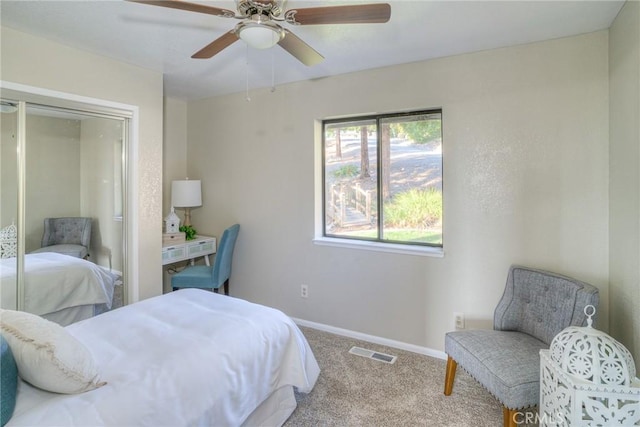 carpeted bedroom featuring ceiling fan and a closet