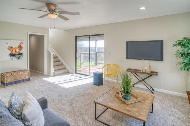 carpeted living room with ceiling fan