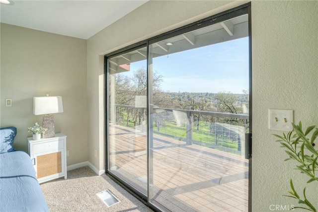 entryway featuring plenty of natural light and carpet floors