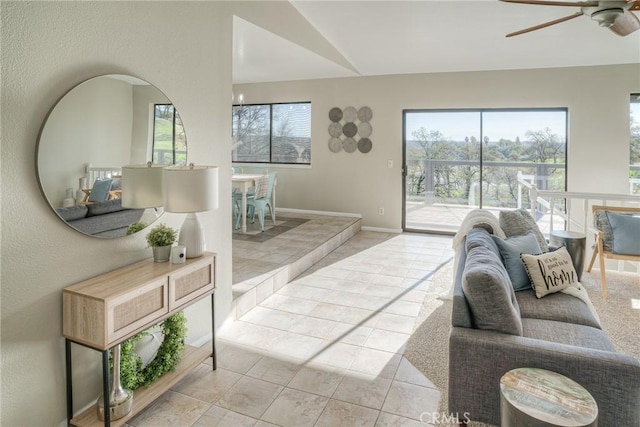 living room featuring ceiling fan, lofted ceiling, and light tile patterned floors