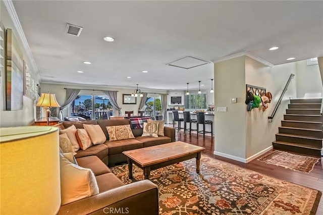 living room featuring hardwood / wood-style flooring and ornamental molding