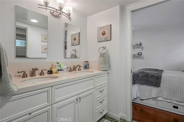 bathroom with vanity and a notable chandelier