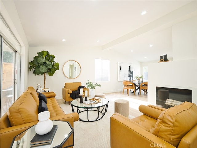 living room featuring light hardwood / wood-style flooring and beamed ceiling